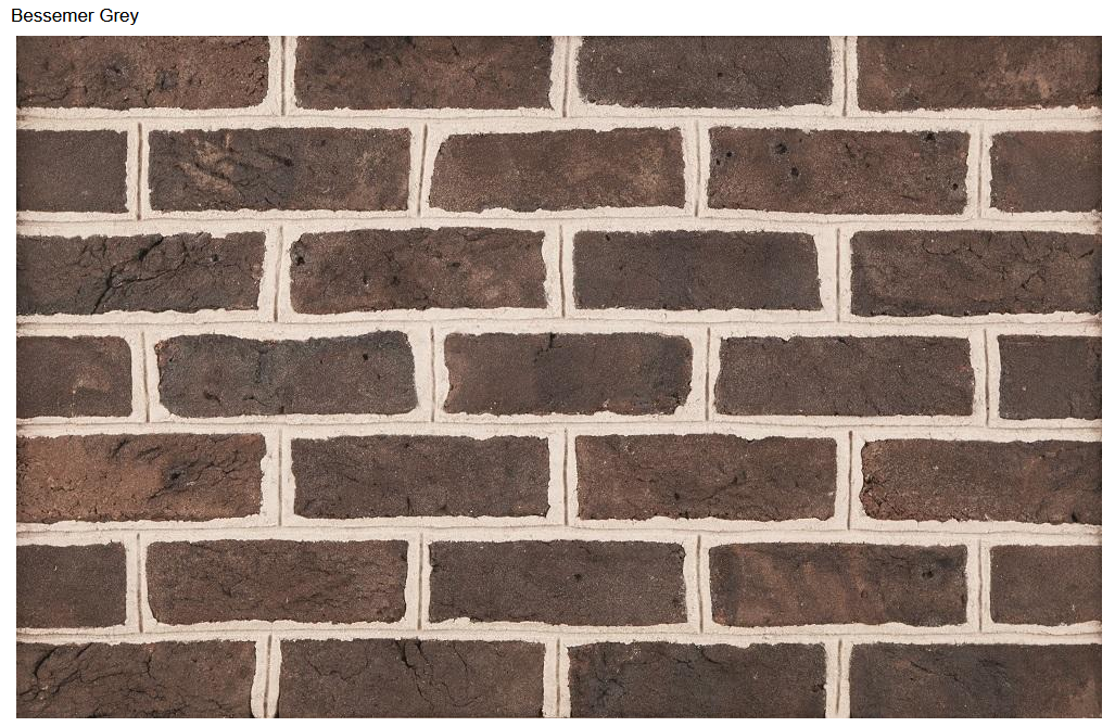 Brick wall with dark brown bricks and white mortar.