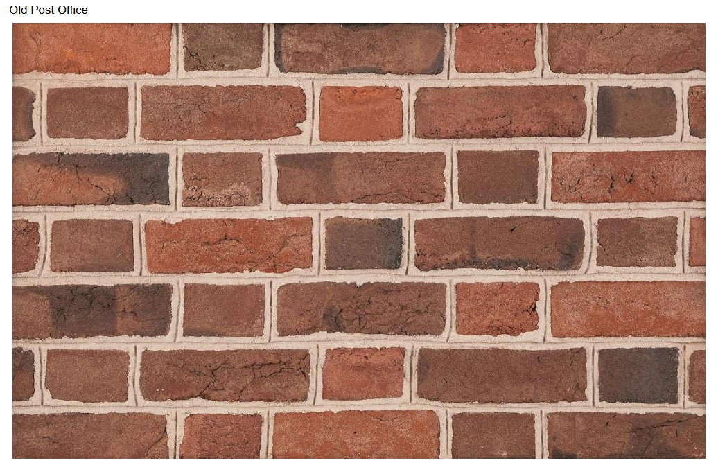 Red and brown brick wall with white mortar.