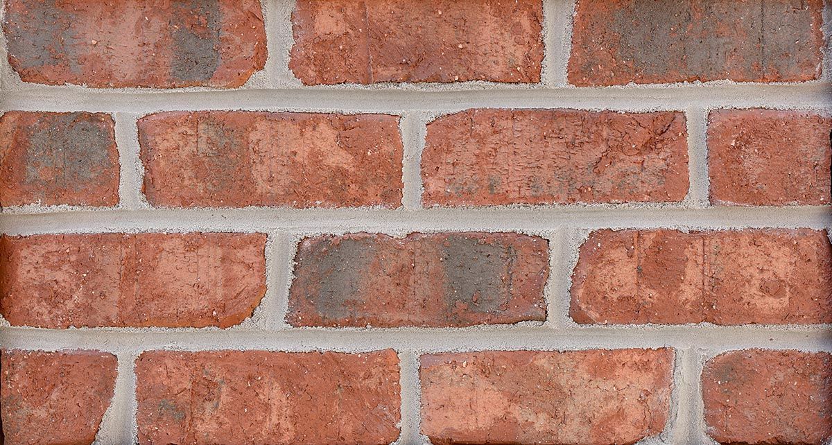 Red brick wall with gray mortar joints.