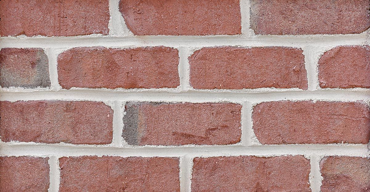 Close-up of red bricks with white mortar.