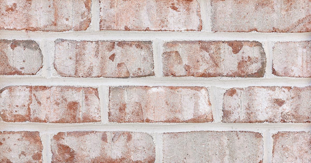 Red and white brick wall, mortar joints visible.
