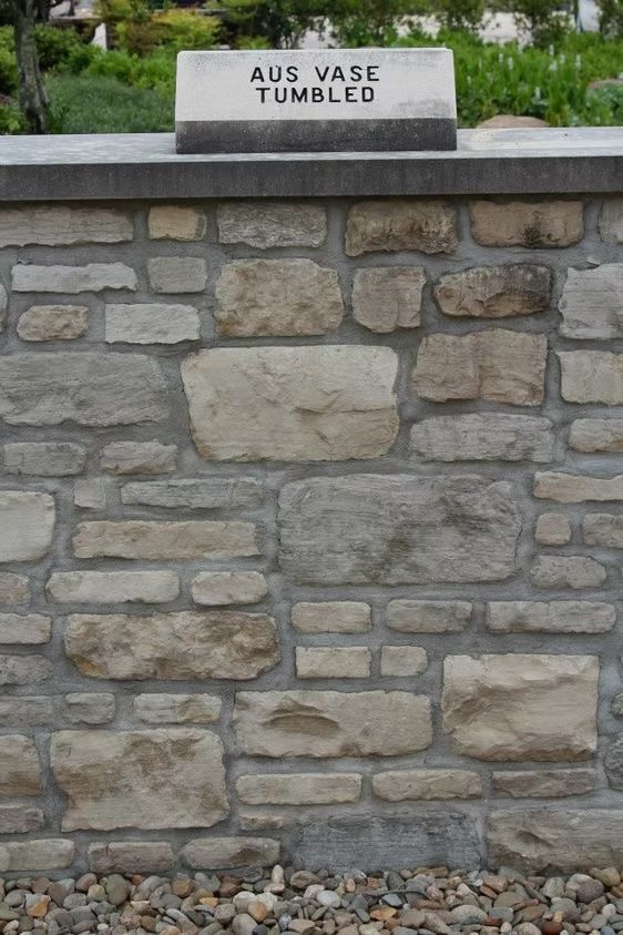 Stone wall with a sign that reads 