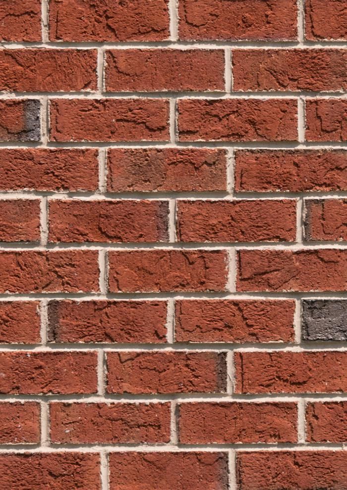 Close-up view of a red brick wall with white mortar.