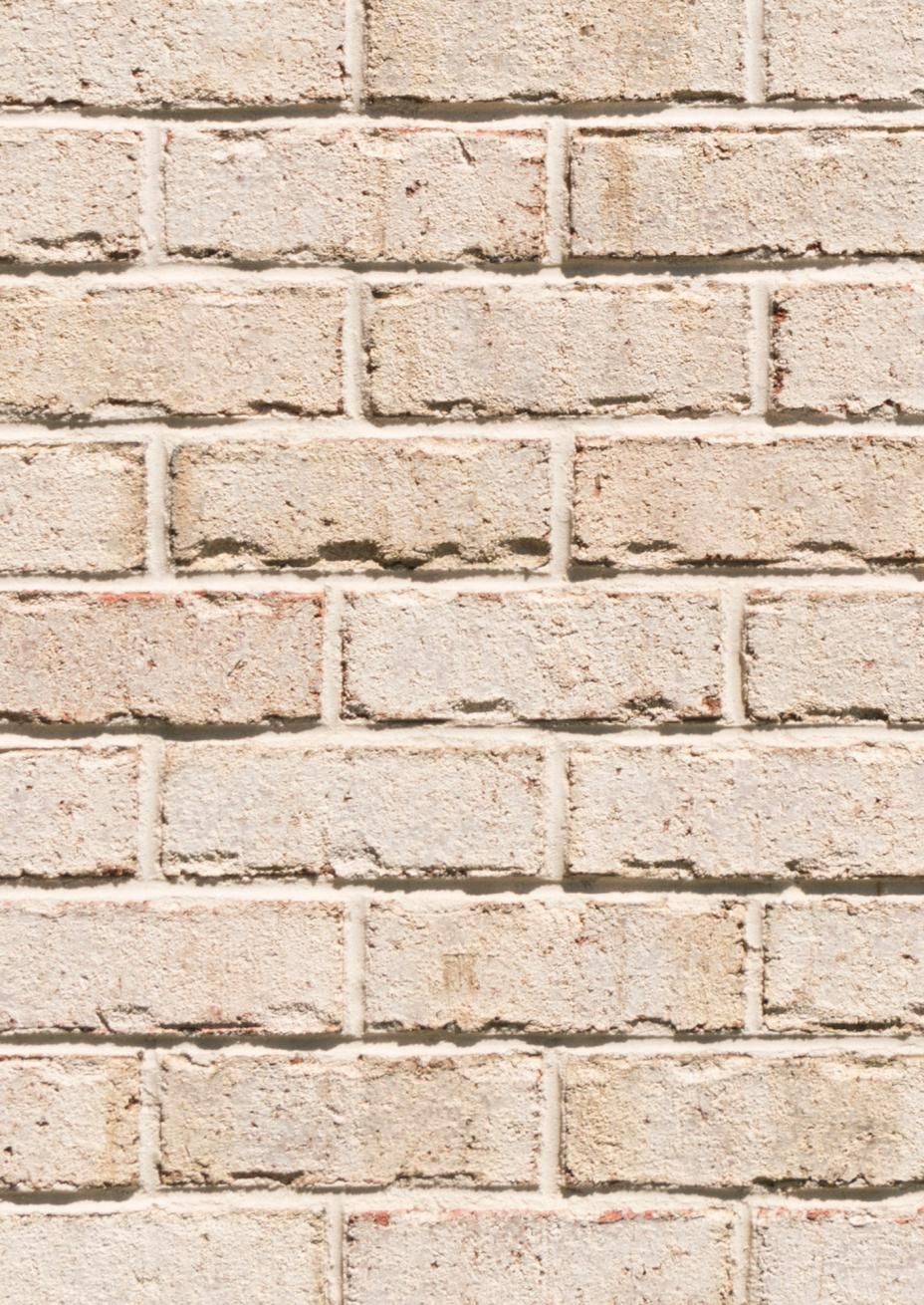 Tan brick wall with visible mortar.