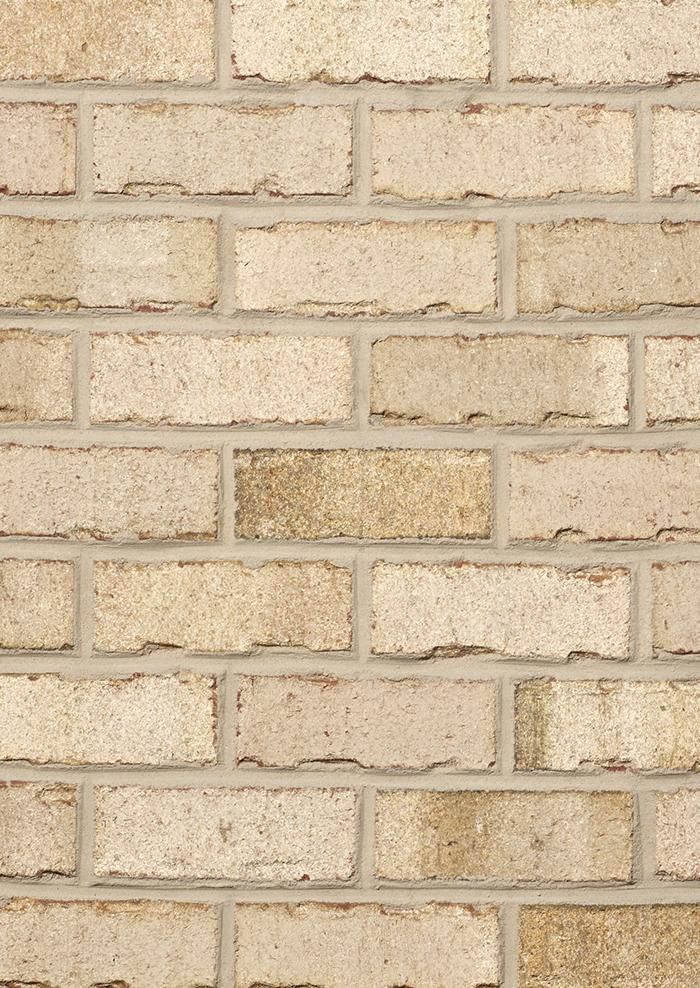 Tan brick wall with gray mortar.