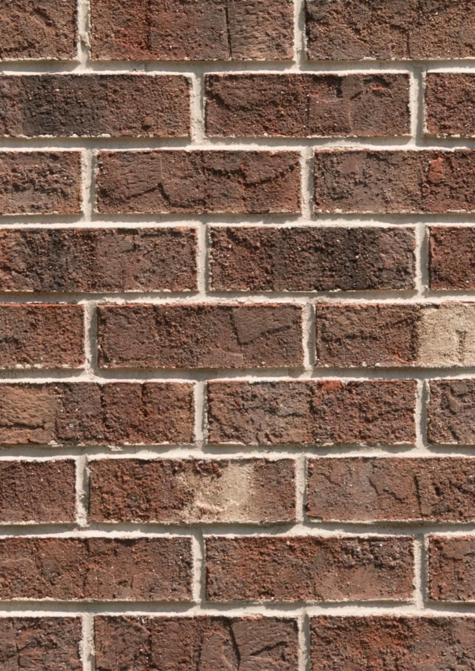 Brick wall with brown bricks and white mortar.