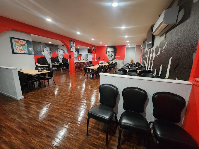 A restaurant with a lot of tables and chairs