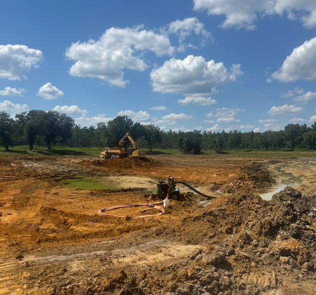 Heavy equipment preparing land for site work and foundation installation