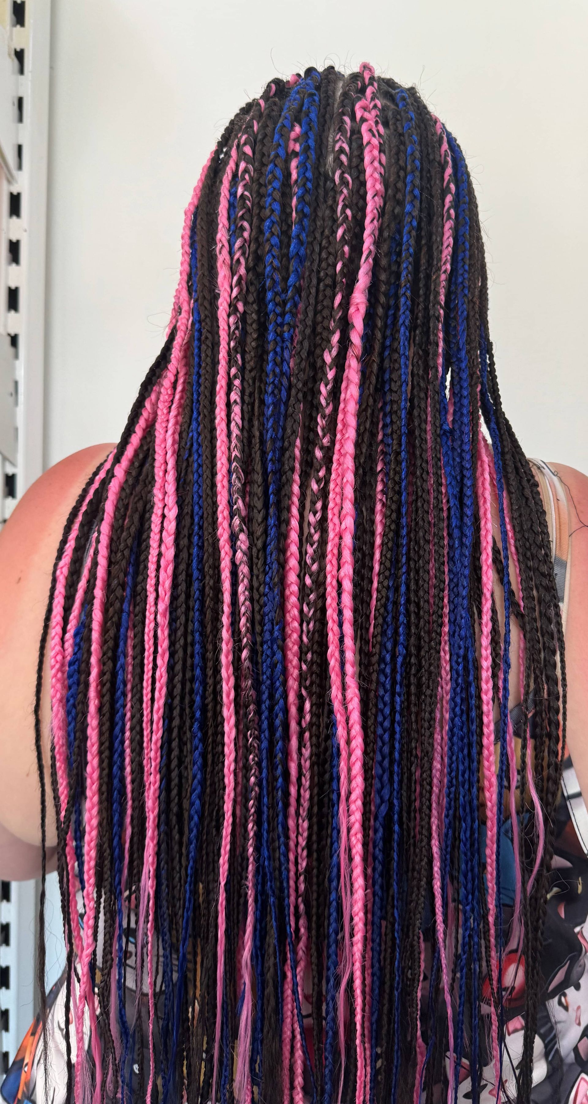 A woman with pink and blue braids in her hair.
