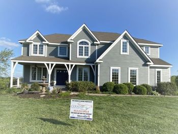 A large house with a sign in front of it that says 