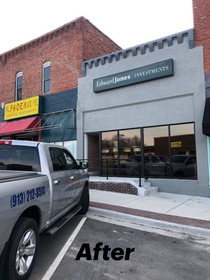 A truck is parked in front of a building that says phoenix