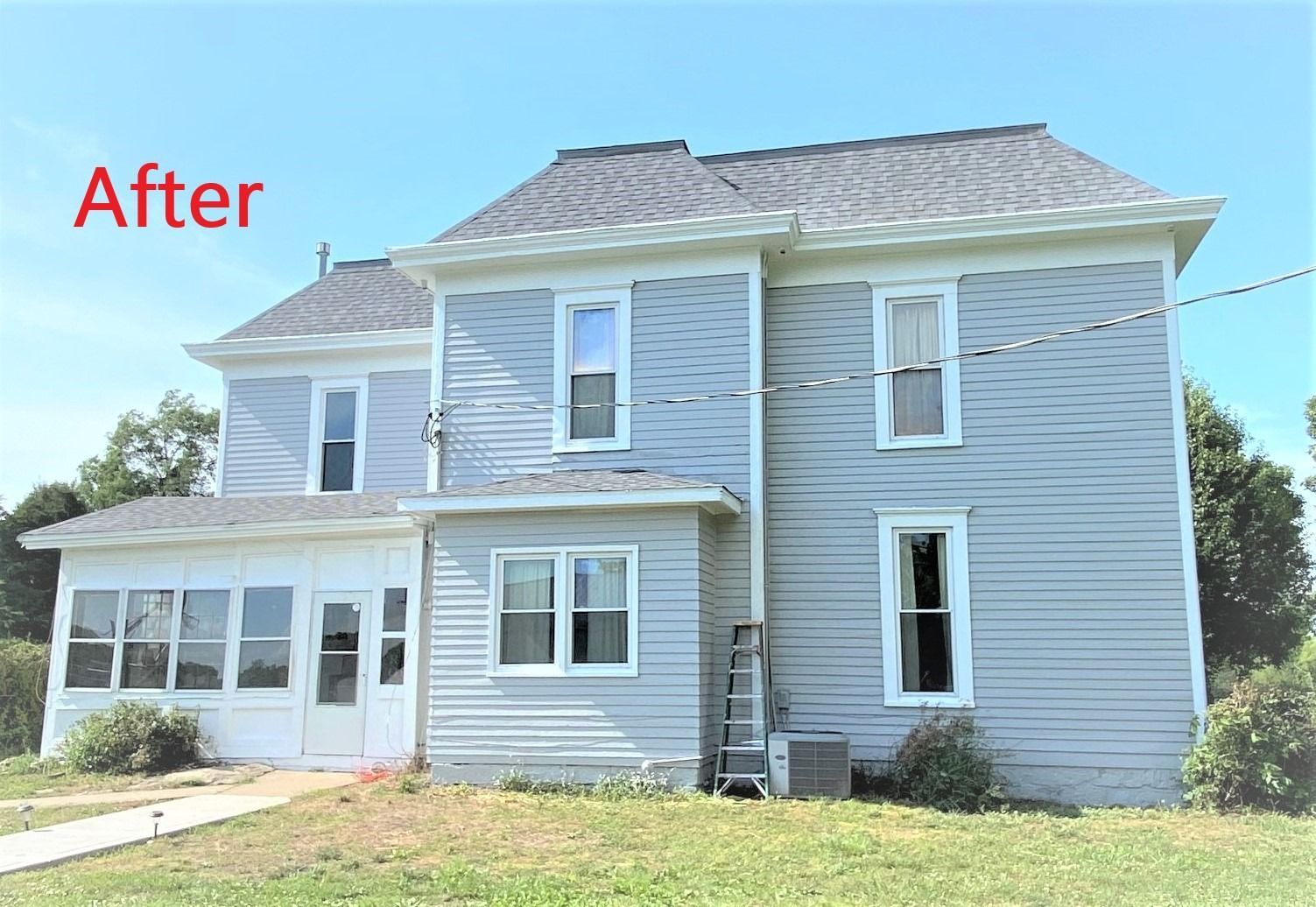 A picture of a house after being painted white