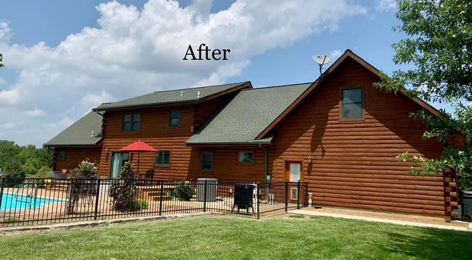 A large log cabin with a swimming pool in the backyard.