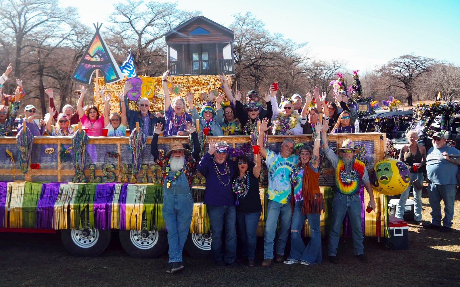 A group of people are standing in front of a float in a parade.
