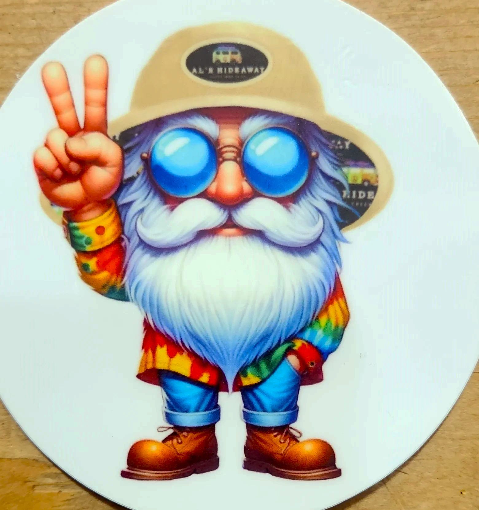 A man with a beard wearing a hat and sunglasses giving a peace sign