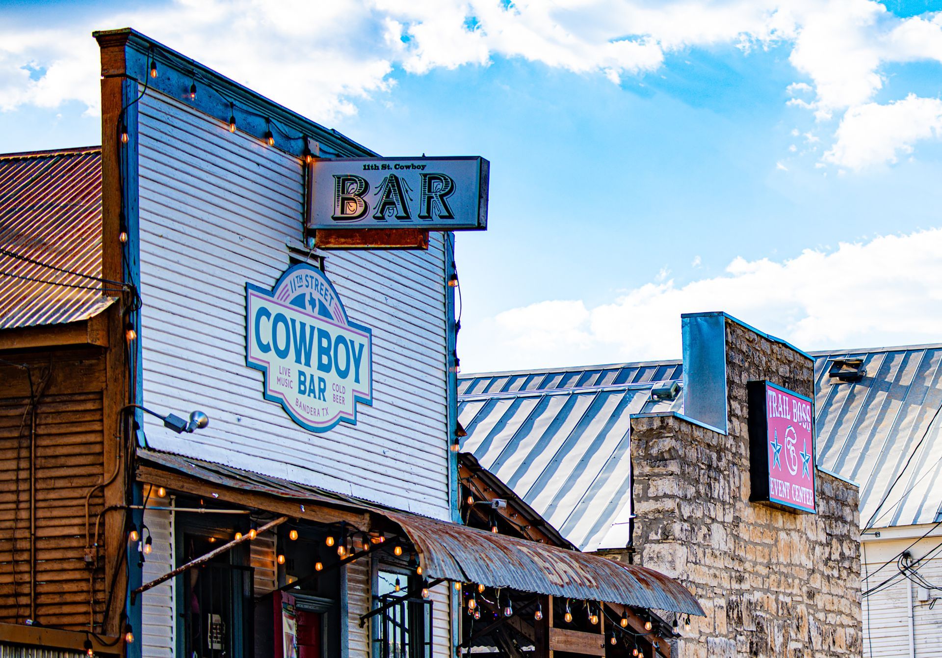 A cowboy bar is located on the side of a building.
