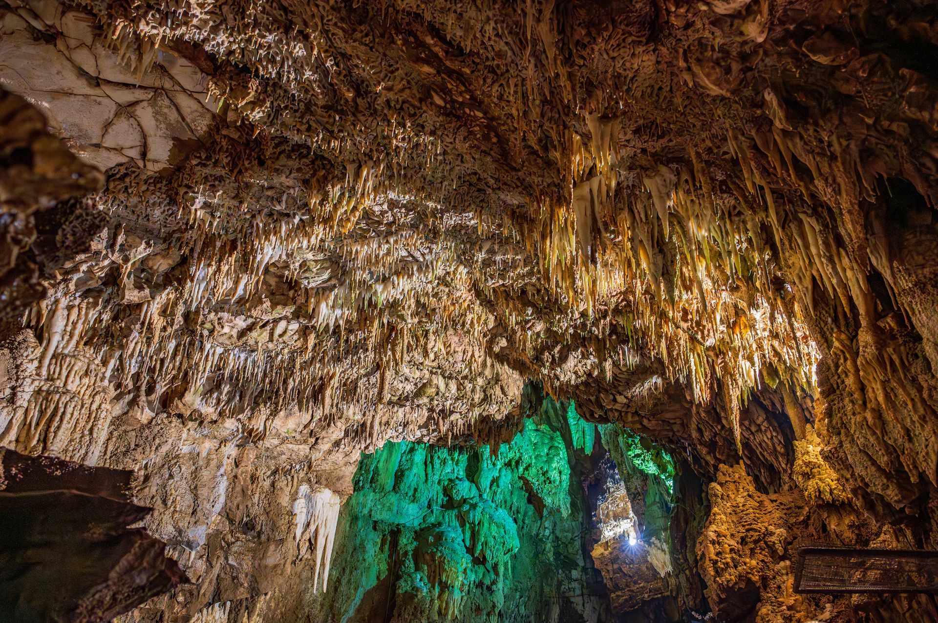 A cave with a green light in the middle of it.
