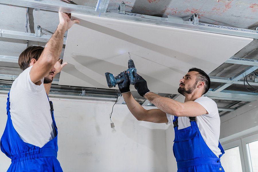 worker drilling the ceiling