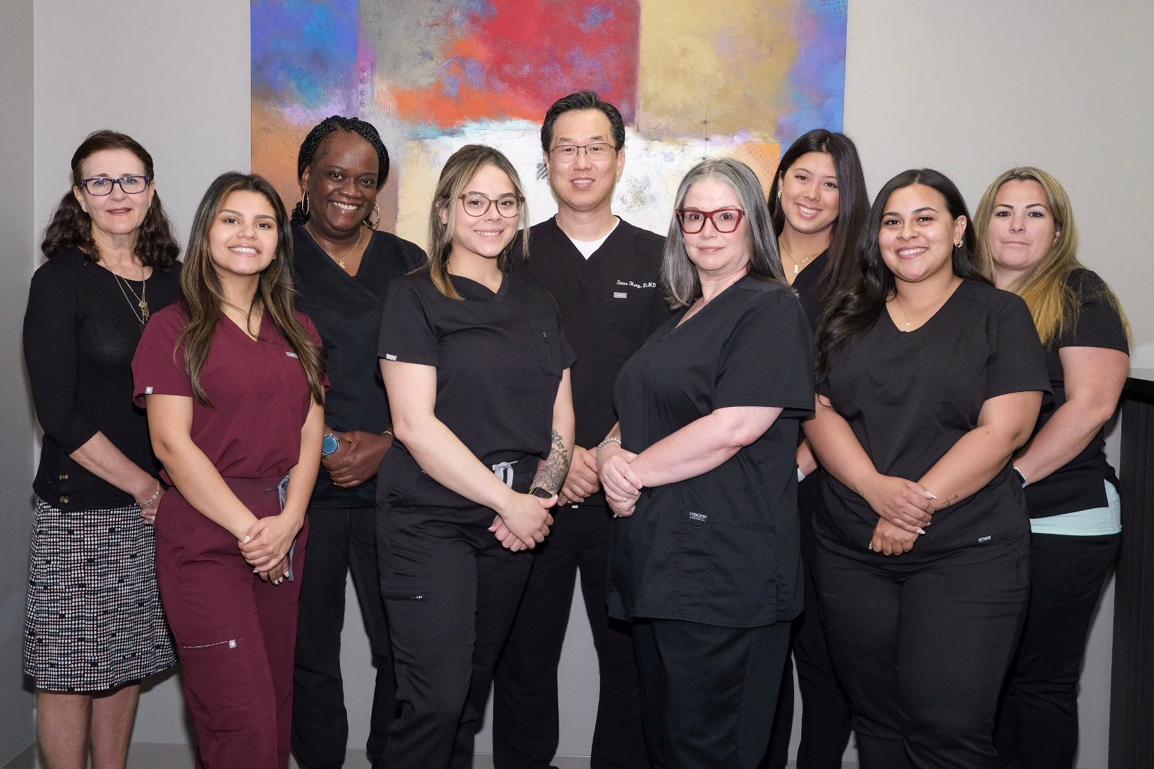A group of women in scrubs are posing for a picture.