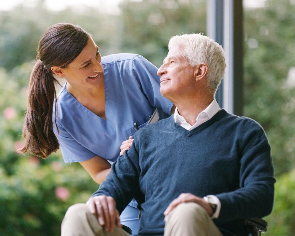 Senior Man in a Wheelchair with Nurse — Lake Charles, LA — Comprehensive Medical Clinic of LA
