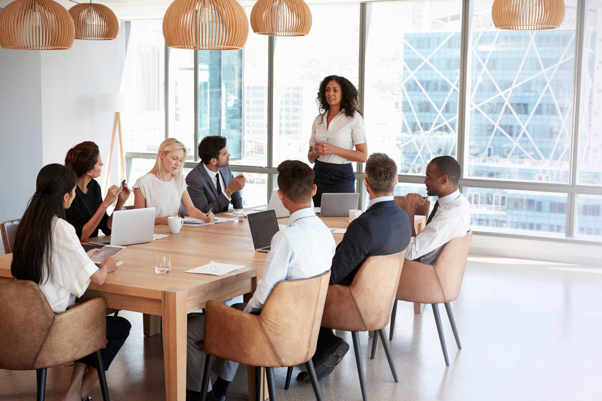 A group of people are sitting around a table in a conference room.