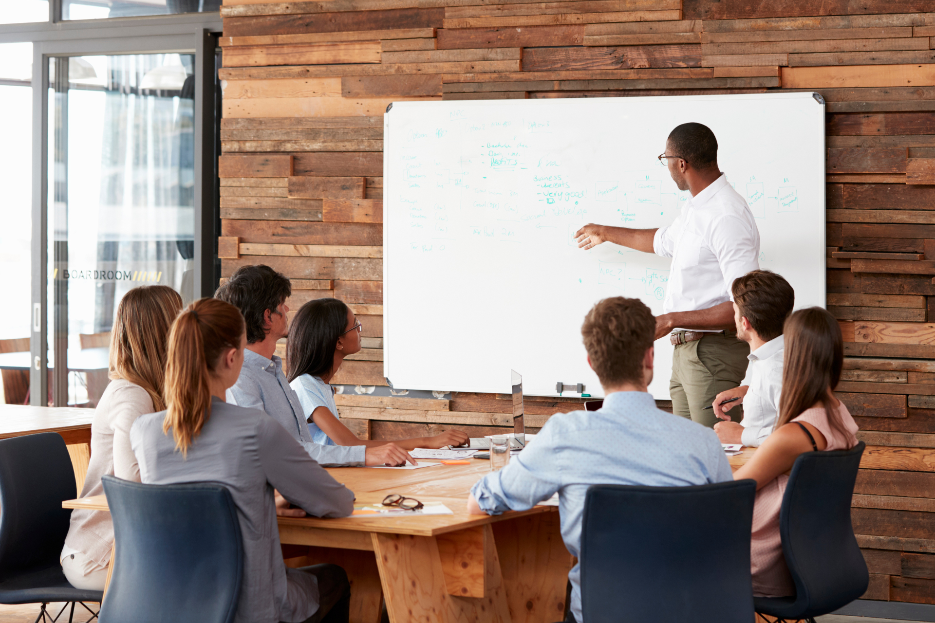 A magnifying glass is sitting on top of a table next to a laptop.