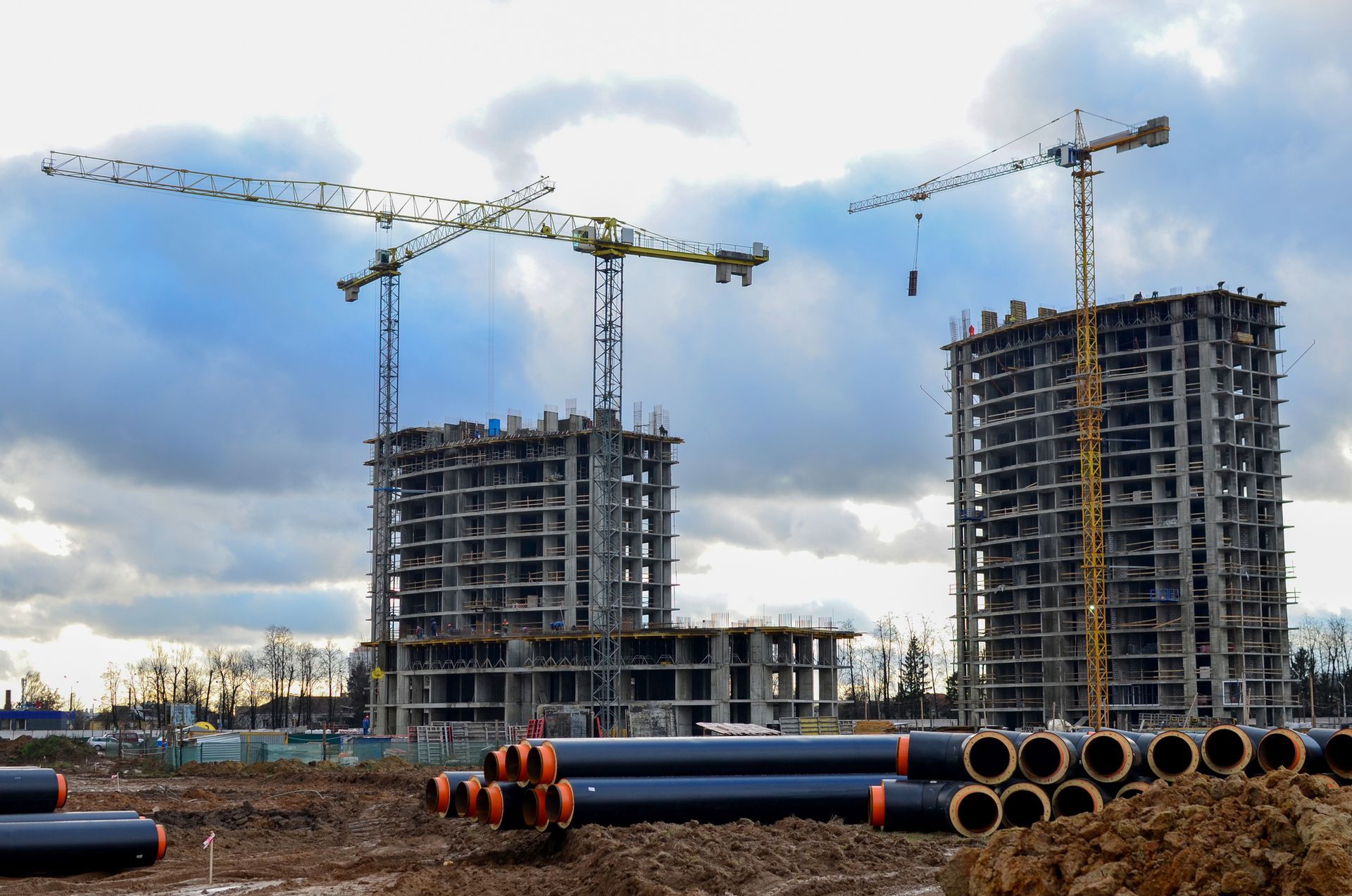 A crane is lifting materials near a tall building.