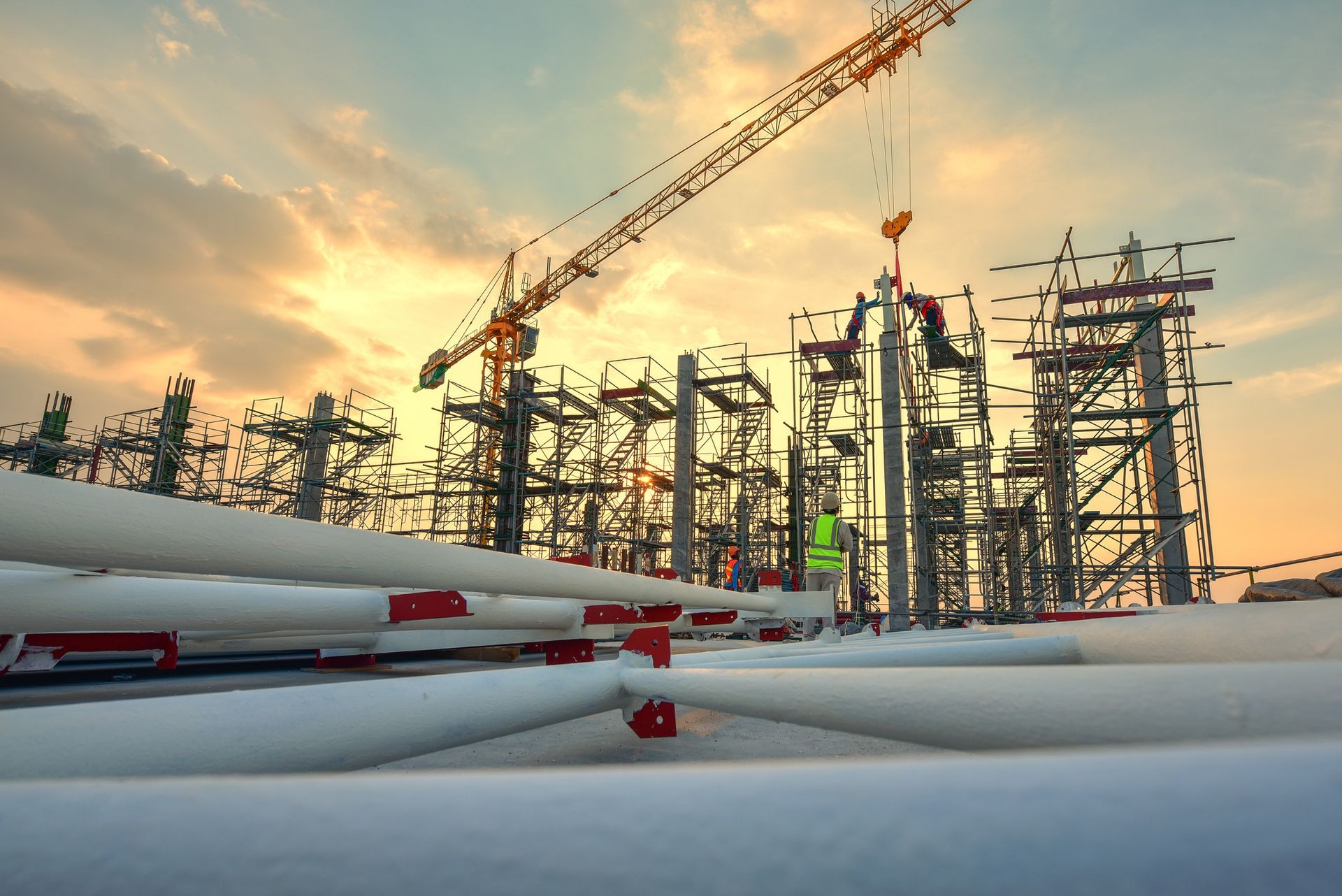 Workers operate a construction crane.