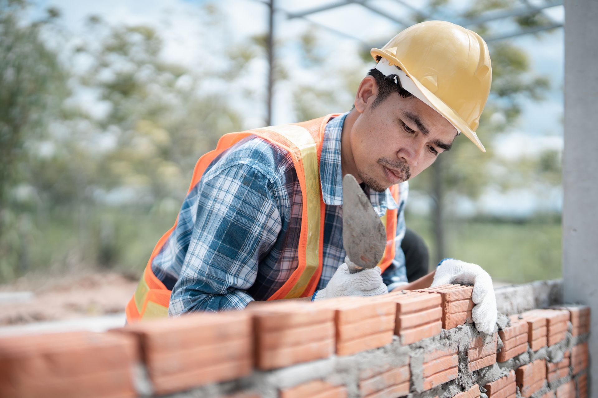 A bricklayer is installing bricks.