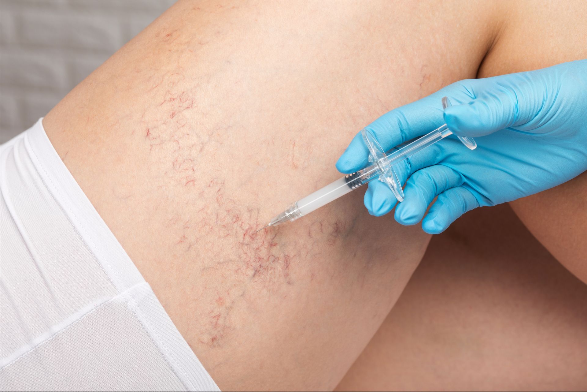 A person is getting an injection in their leg