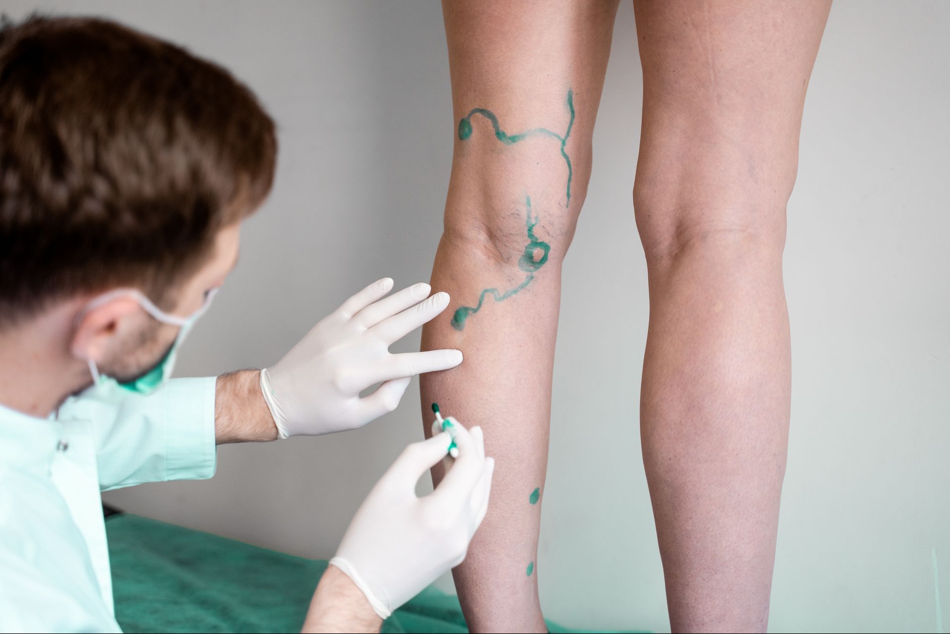 A woman 's leg is being examined by a doctor