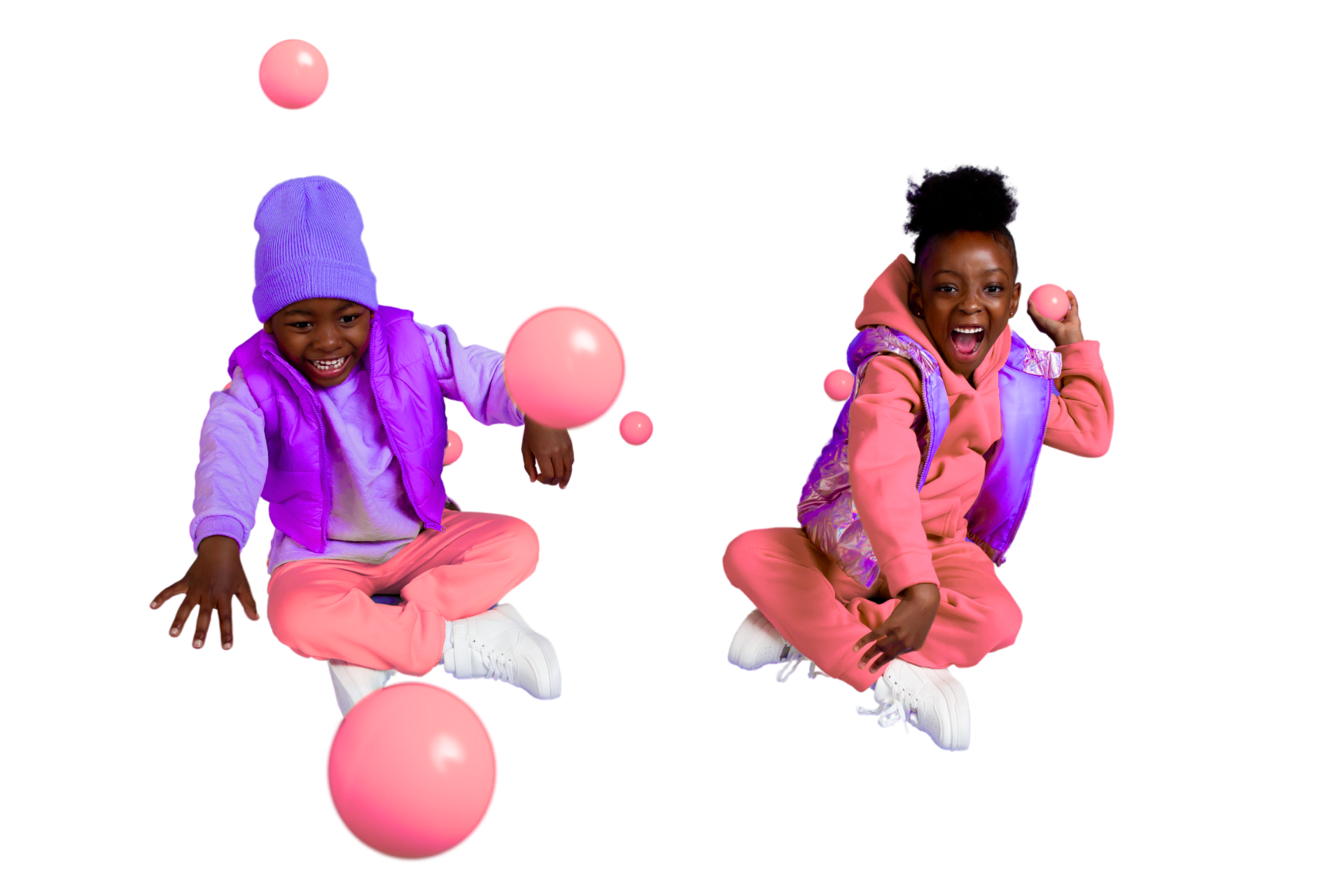 Two little girls are playing with pink balls on a white background.