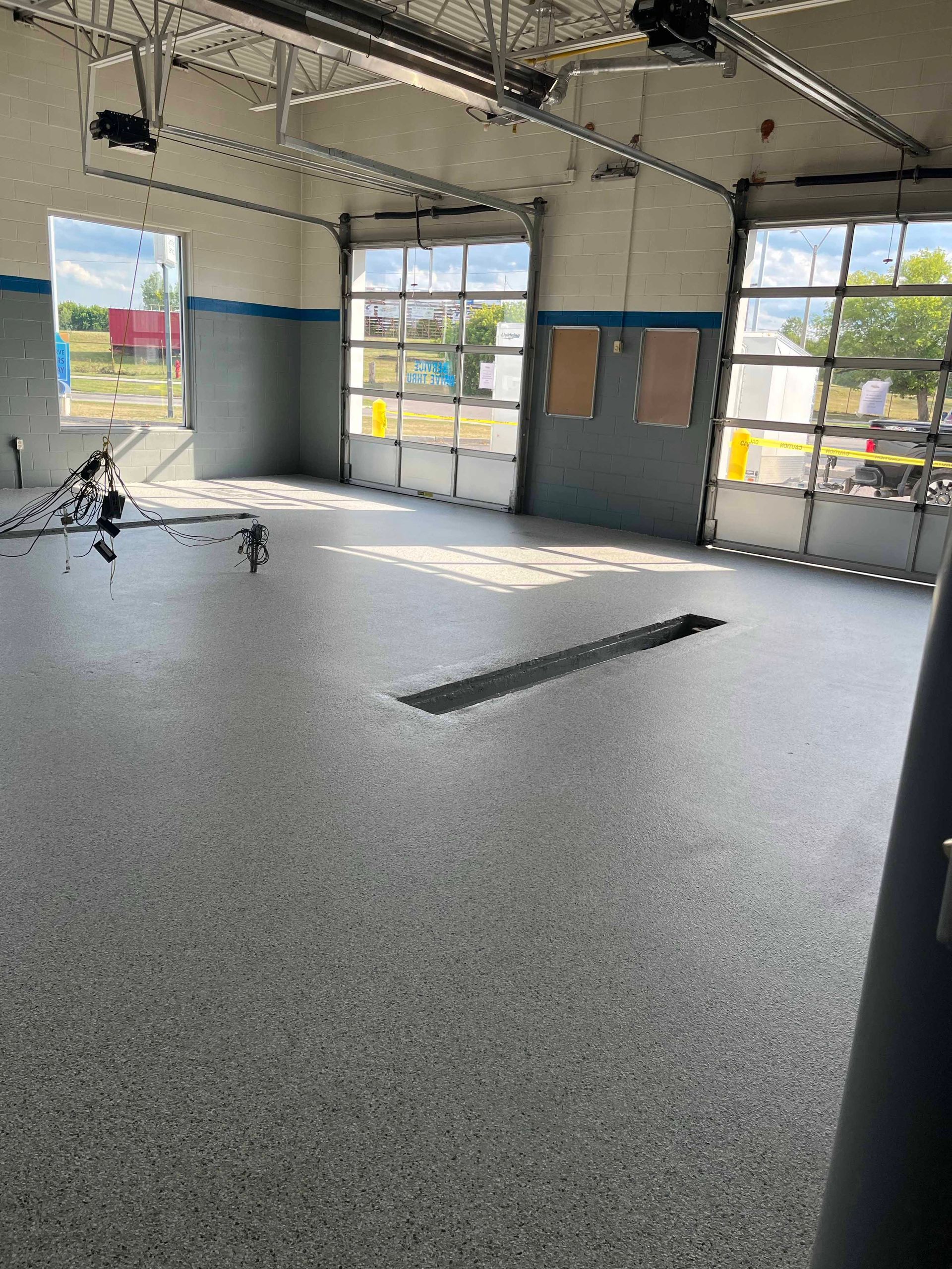 There is a hole in the floor of the garage.