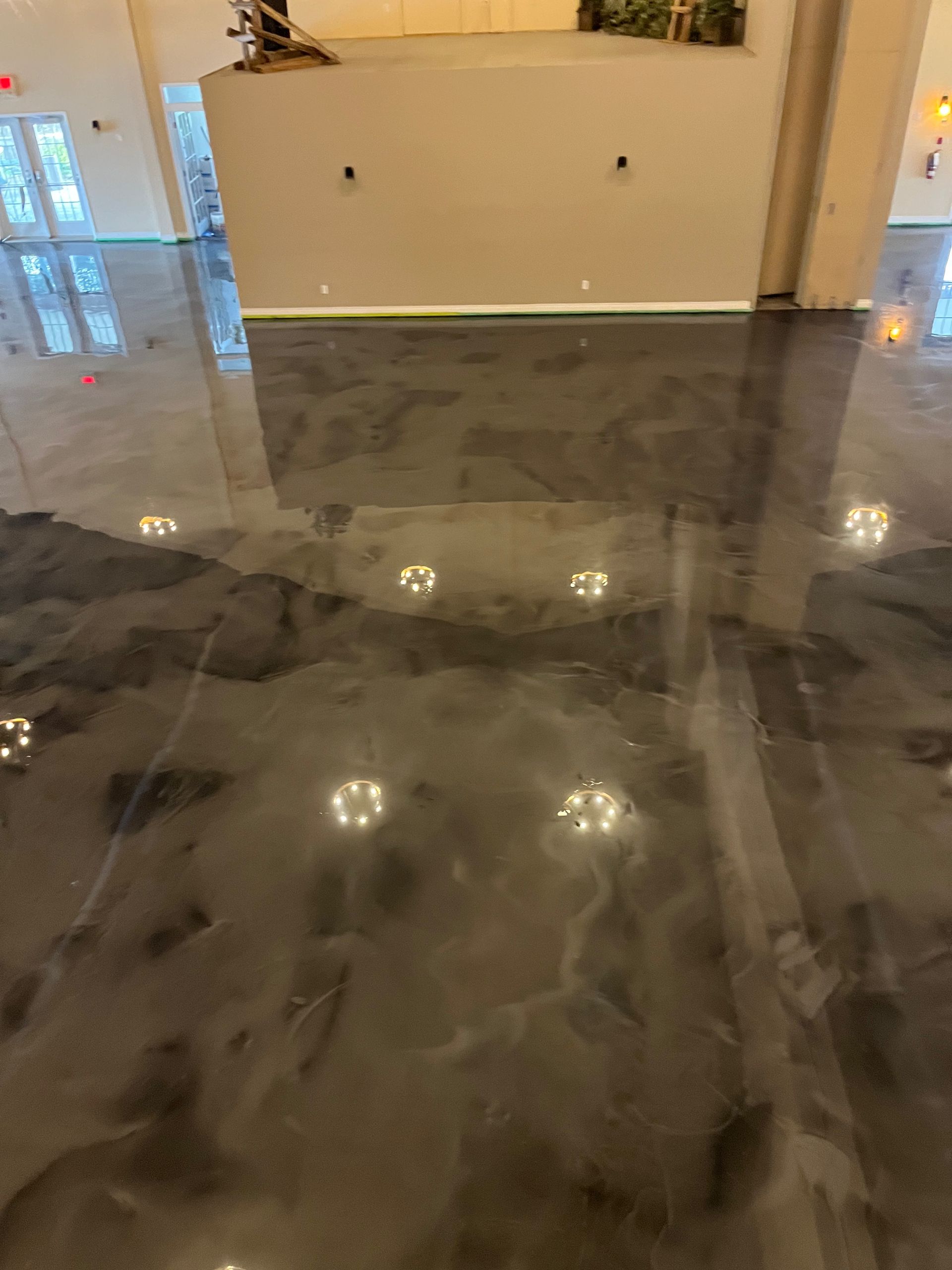 A close up of a shiny metallic floor in a room.