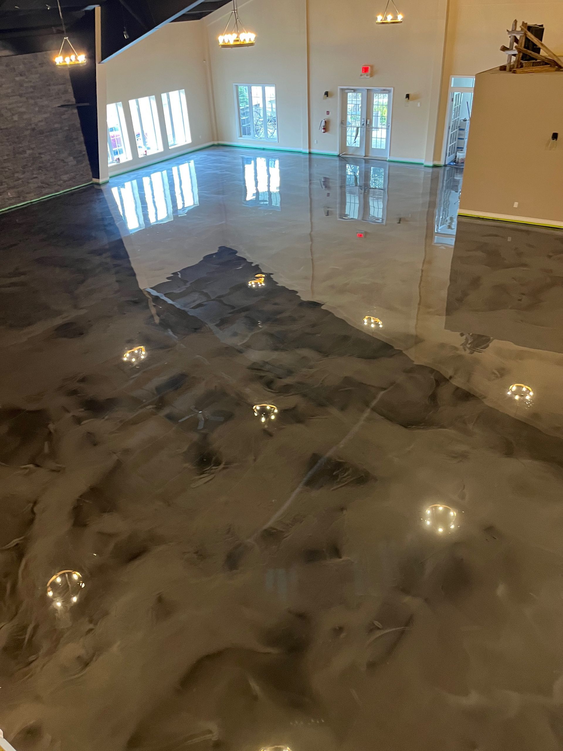 A large room with a shiny floor and a lot of windows.