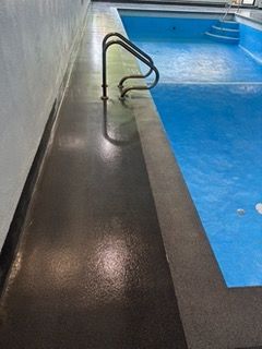 A large indoor swimming pool with stairs leading to it.