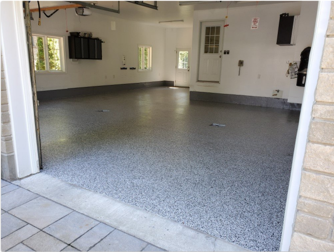 A garage with a gray and white floor
