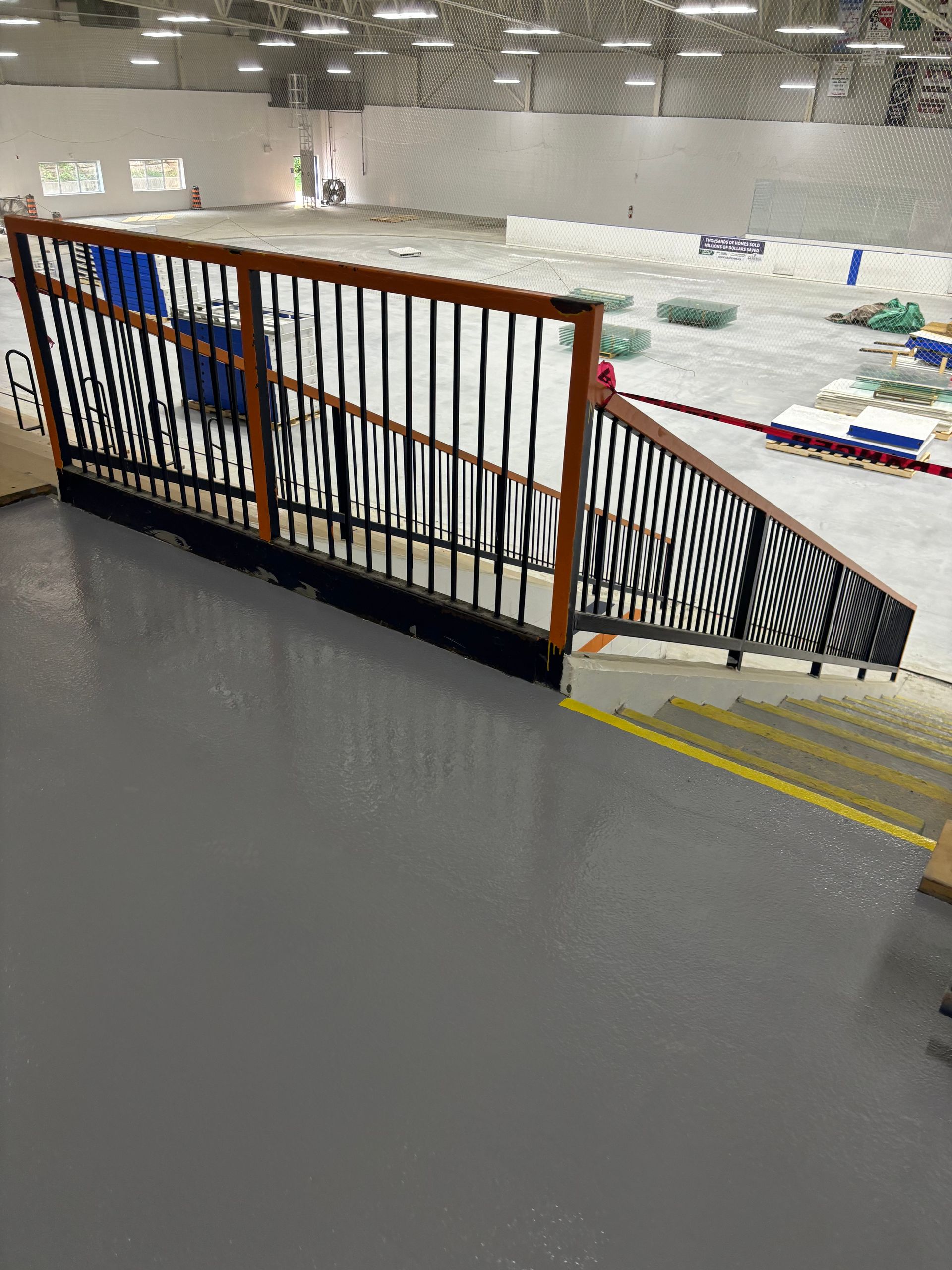 A staircase leading up to an ice rink in a building.