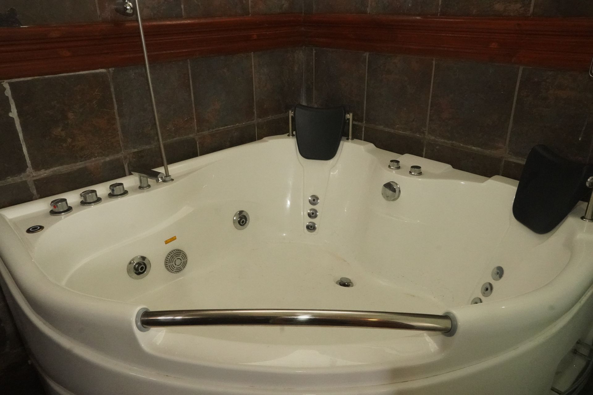 Corner jacuzzi tub with jets and headrests.