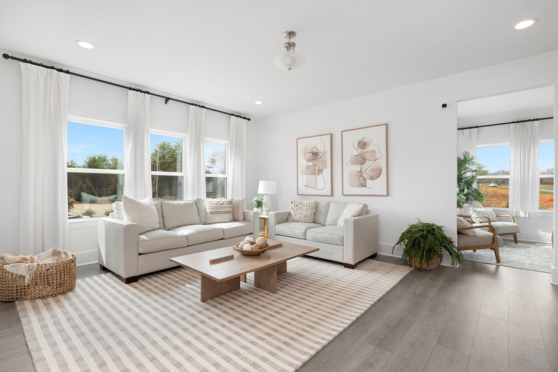 A living room with two couches , a coffee table , and a rug.