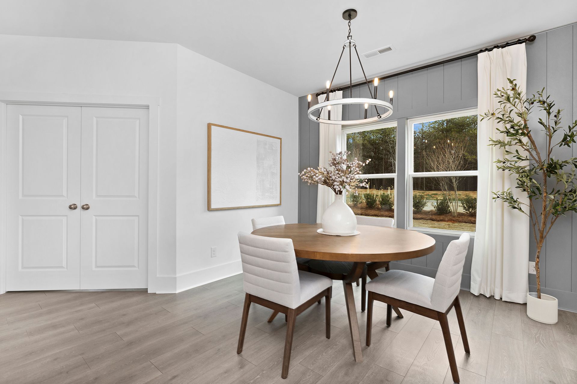 A dining room with a table and chairs and a chandelier.