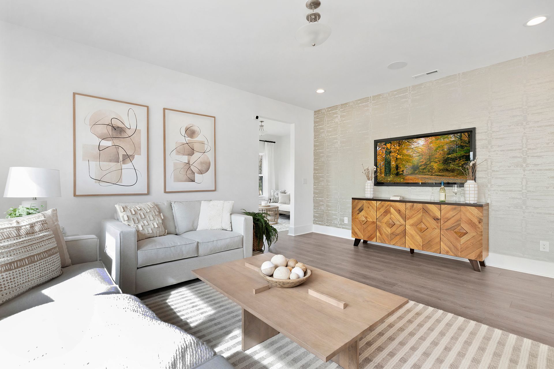 A living room with a couch , coffee table , and television.