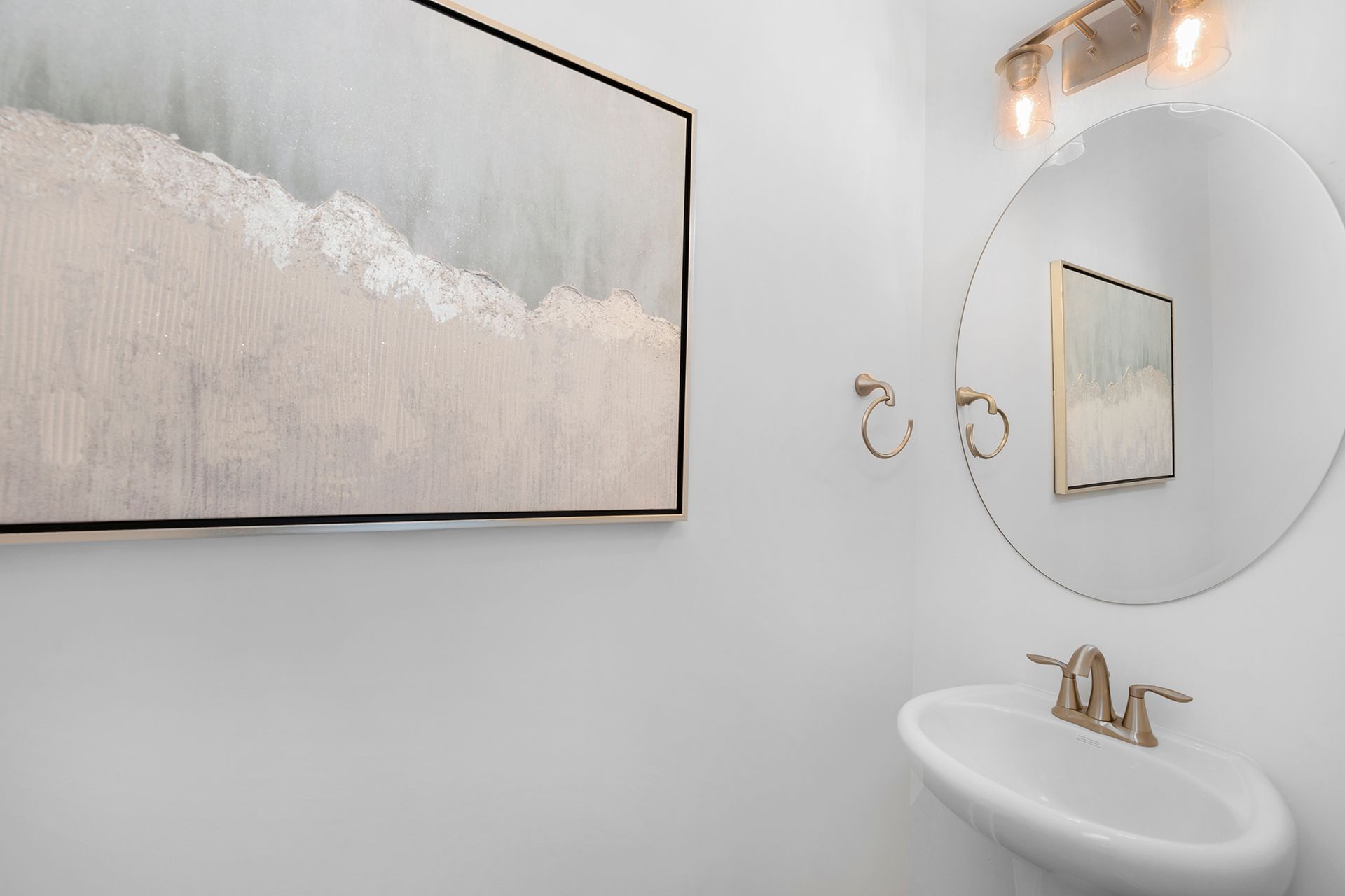 A bathroom with a sink , mirror and painting on the wall.