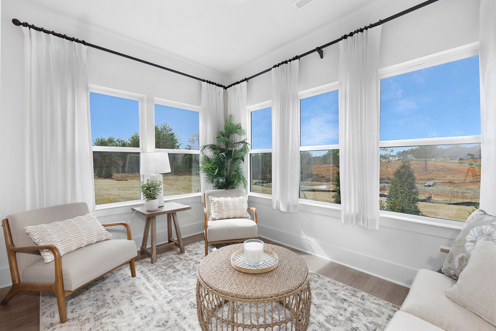 A living room with a couch , chairs , and a coffee table.