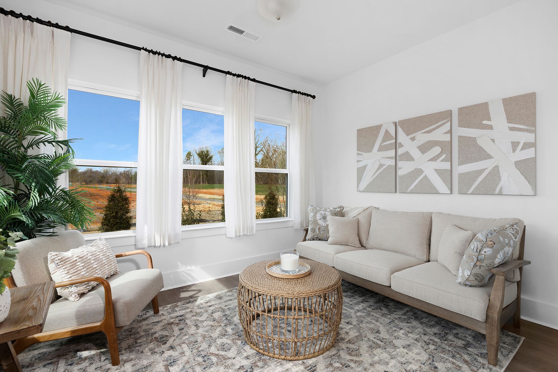 A living room with a couch , chairs , and a coffee table.