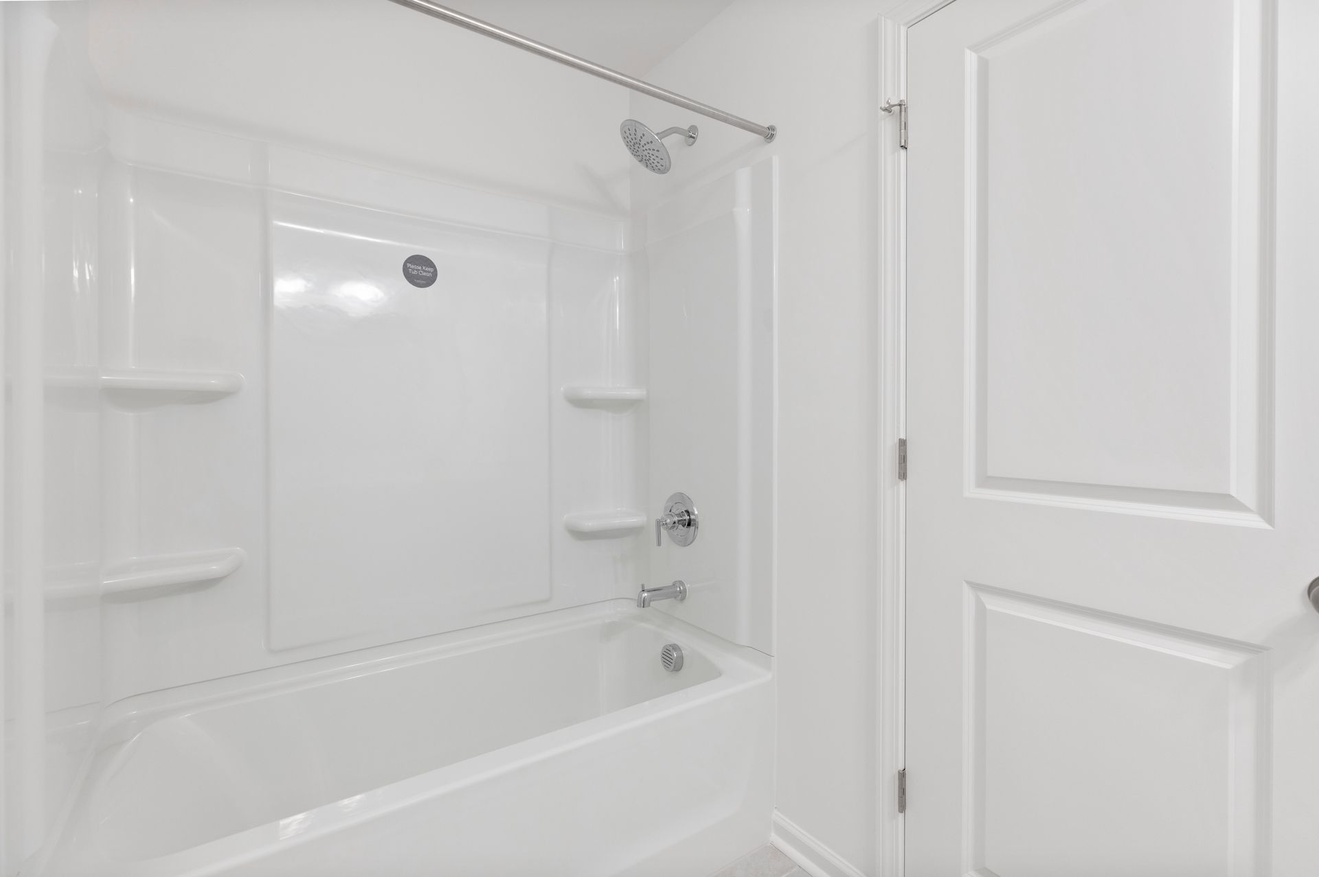 A bathroom with a bathtub and a shower stall.