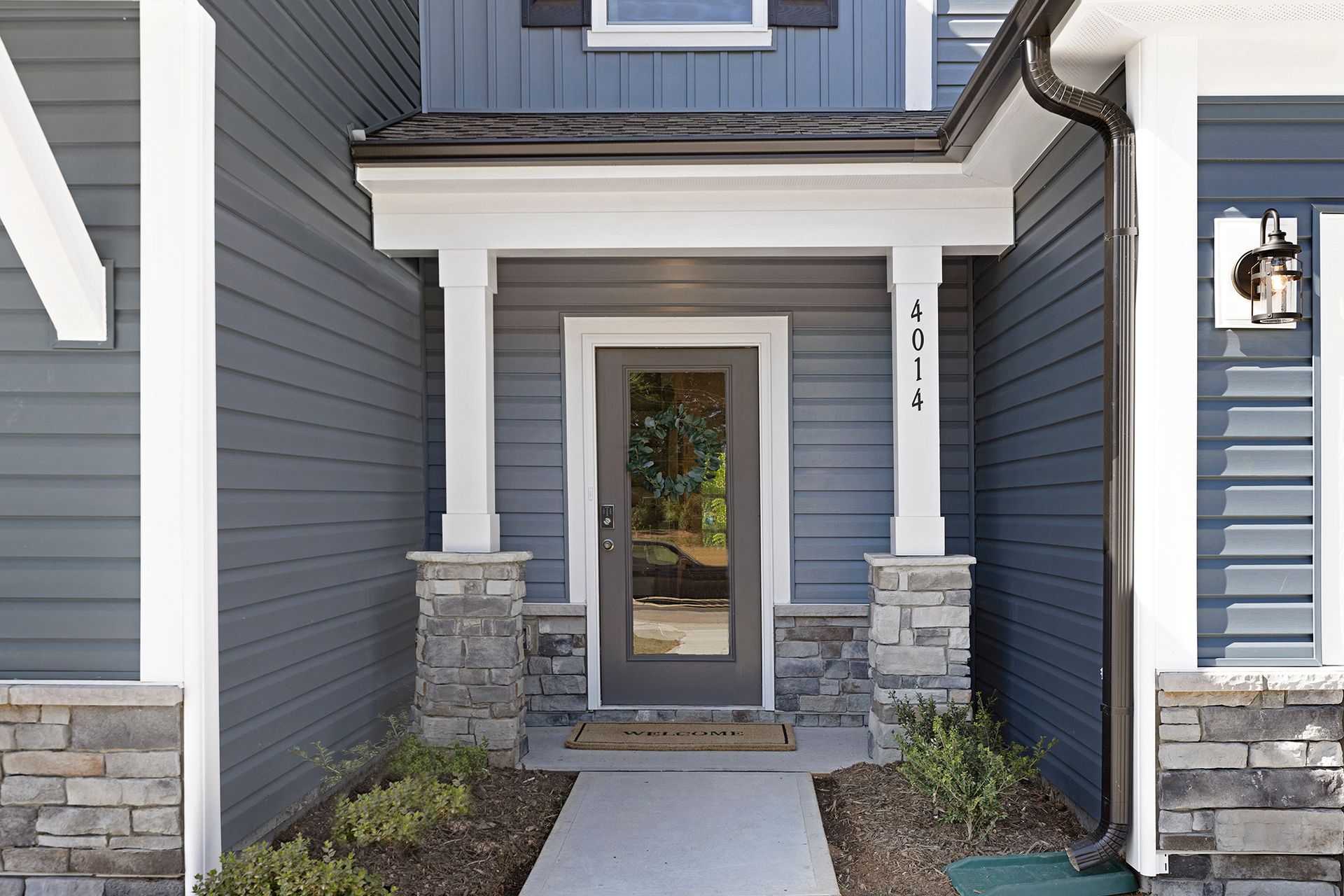 A blue house with a porch and a door