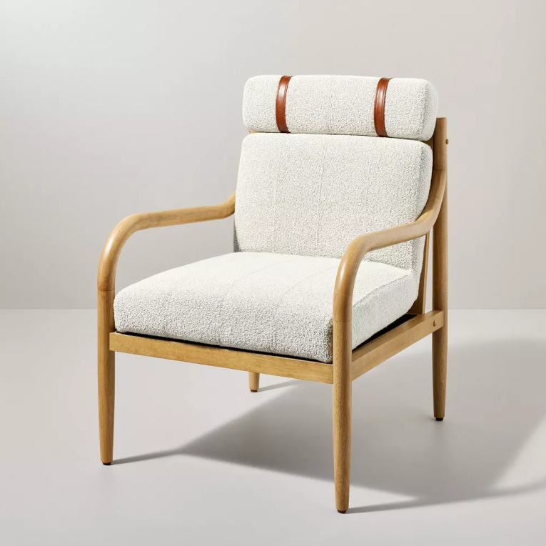 A chair with a white cushion and wooden frame