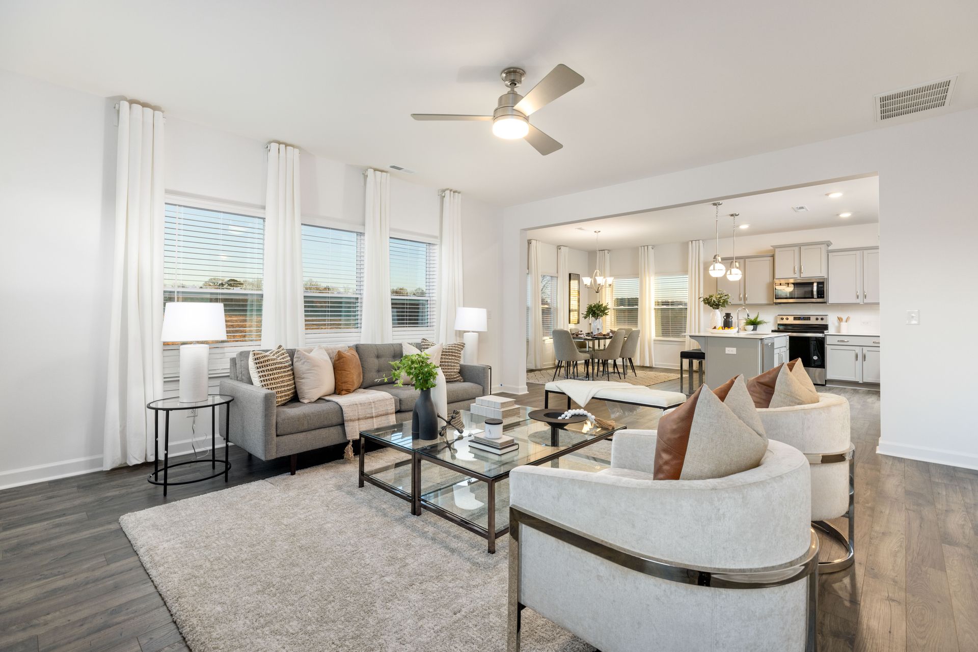 A living room filled with furniture and a ceiling fan.