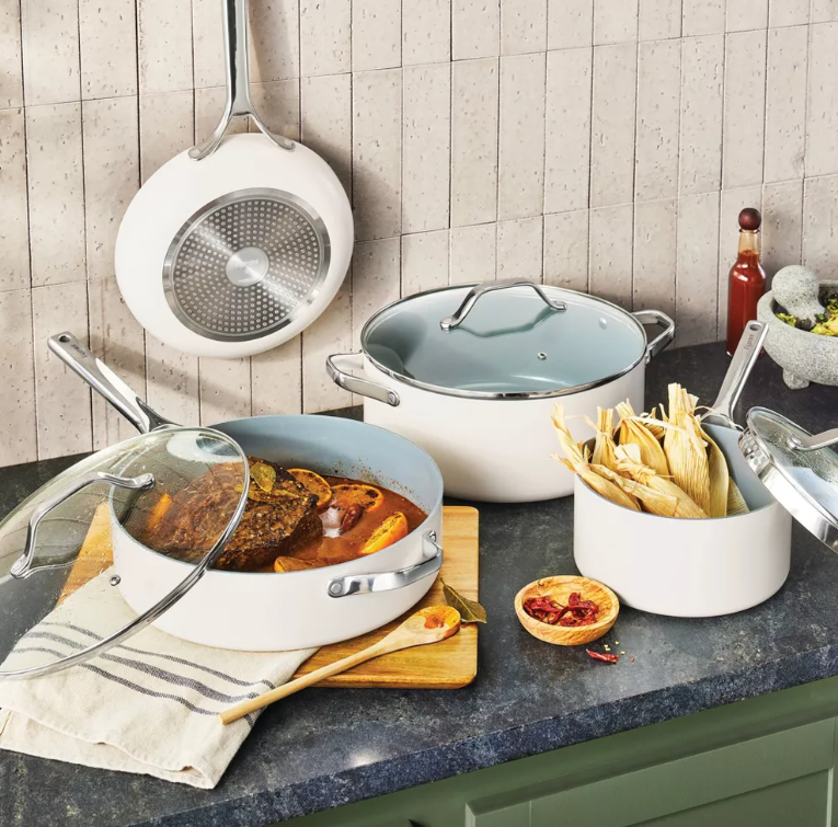 A kitchen counter with pots and pans filled with food